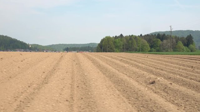 AERIAL: Empty plowed soil lines on agricultural field prepared for crop planting