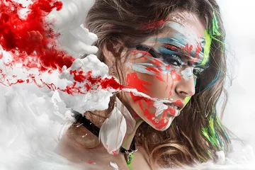Wall murals Female Halloween Painted beautiful woman face, artistic make up, body and face art, close up. Facial expression, emotions. Blood Halloween beauty fashion style in red, yellow, blue colors.
