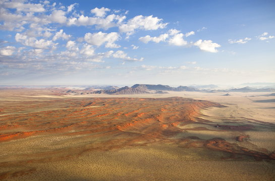 Aerial view from hot air balloon over magnificent desert landscape of sand dunes, mountains and Fairy Circles, Namib Rand game reserve Namib Naukluft Park, Namibia