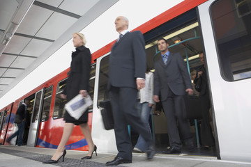 Low angle view of business commuters getting off a train