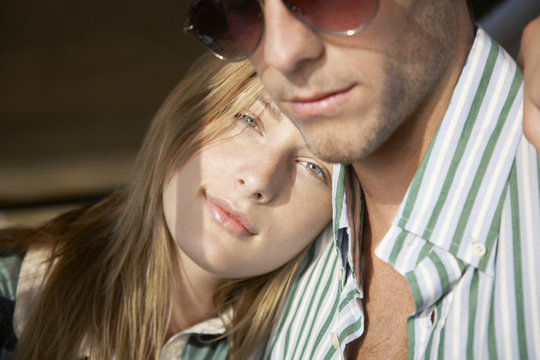 Beautiful Young Woman Resting Head On Boyfriend's Shoulder During Road Trip