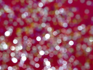 красивые разноцветные блики на красном фоне      