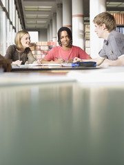 Multiethnic students discussing homework in the library