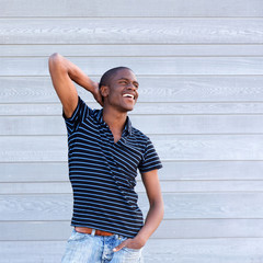 Obraz premium handsome young black guy smiling with hand behind head