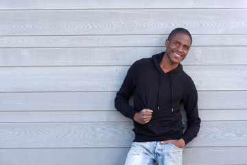 cool young black guy smiling with black sweatshirt