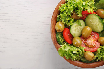 Tasty vegetable salad on kitchen table