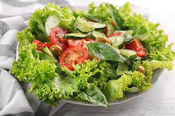 Tasty vegetable salad on kitchen table
