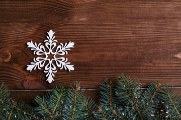 Christmas background with xmas tree and sparkle bokeh lights on wooden canvas background. Merry christmas card. Winter holiday theme. Happy New Year. Space for text. Happy Holidays