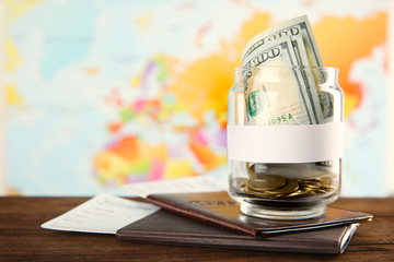 Passports with tickets and money for vacations on the world map background