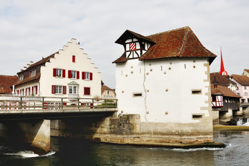 Fototapeta na wymiar Swiss characteristic house and bridge over Reuss river in Bremgarten, Switzerland