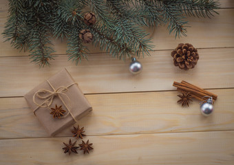 Christmas fir tree and gifts on wooden background.