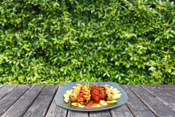 meatball in plate on woodtable and leaf background