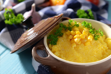 Tasty breakfast of cornmeal porridge on napkin, closeup
