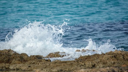 Detailed view of waves breaking on a stony beach