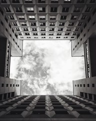 Black and white building. Sky with clouds