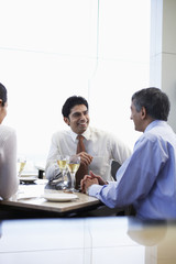 Three business people having a discussion at restaurant