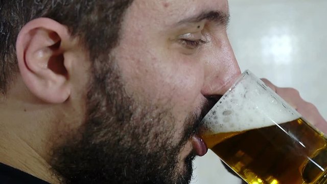 side view of young man drinking beer