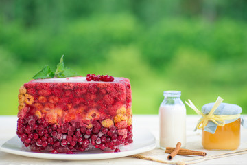 Jelly with berry on white rustic wood background