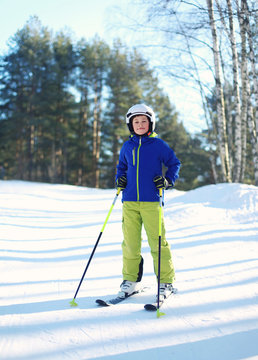 Professional skier child boy in sportswear helmet on ski winter,