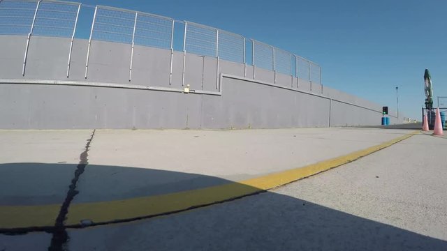 Racecar driving trough pit lane on the racetrack to practice qualifying lap