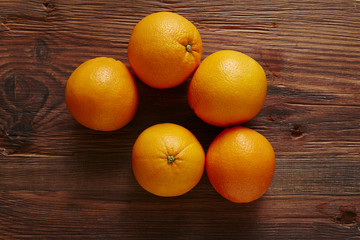 five organic oranges in a pile