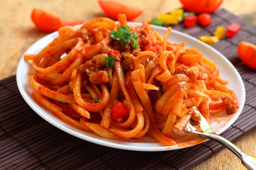 Pasta with pork and tomato sauce.