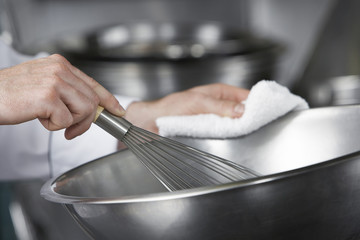 Closeup of hands mixing ingredients in a bowl