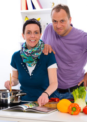 man and woman cooking together