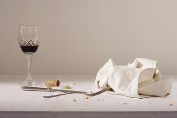 Wine glass cutlery dish cloth on messy table