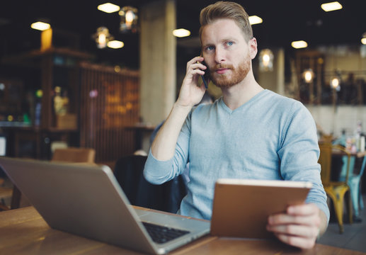 Occupied Businessman Multitasking In Cafe