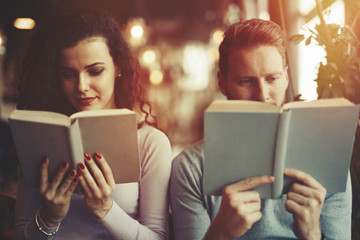 Young university students reading books