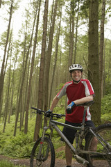 Portrait of a smiling male cyclist in the forest