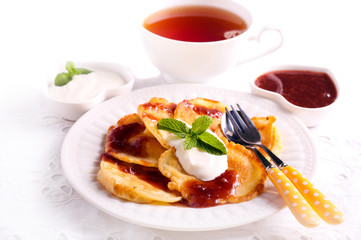 Apple fritters served with jam and yogurt