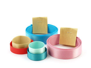 group of colorful roll ribbons with gold label isolated on white