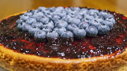 Blueberry cheesecake. Homemade cheesecake pie with blueberries and jam. Detailed fruit composition.