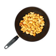 Prepared chicken fillet cutted into pieces and spiced in pan isolated over white background