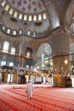 Blue Mosque interior, mullah in foreground, Istanbul, Turkey