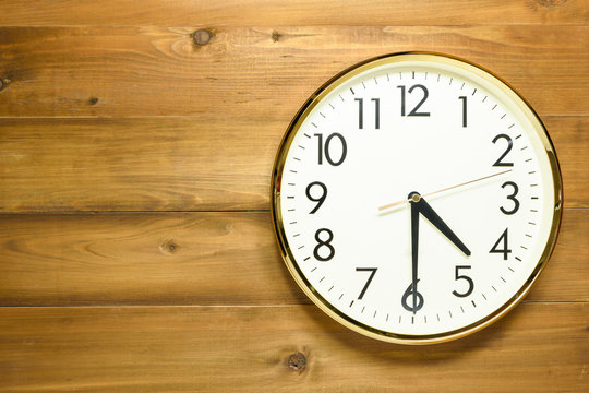 wall clock on the wooden wall