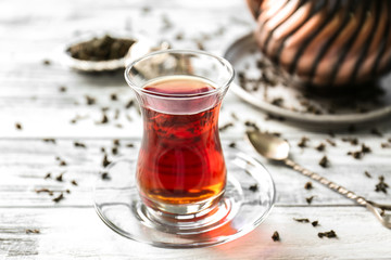 Turkish tea in traditional glass on wooden background