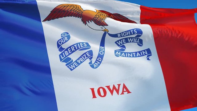 Iowa (U.S. state) flag waving in slow motion against blue sky, seamlessly looped, close up, isolated on alpha channel with black and white matte, perfect for film, news, composition