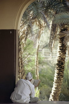 Man reading Koran in mosque, Malindi, Kenya