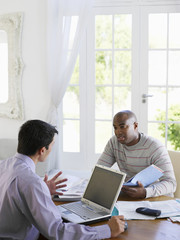 African American man sitting at table with financial advisor