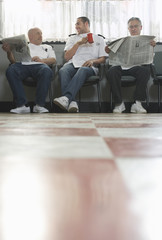 Three barbers waiting for customers in barbershop