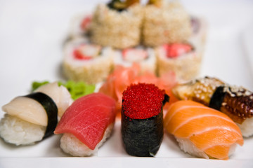 Japanese rolls and sushi on white plate
