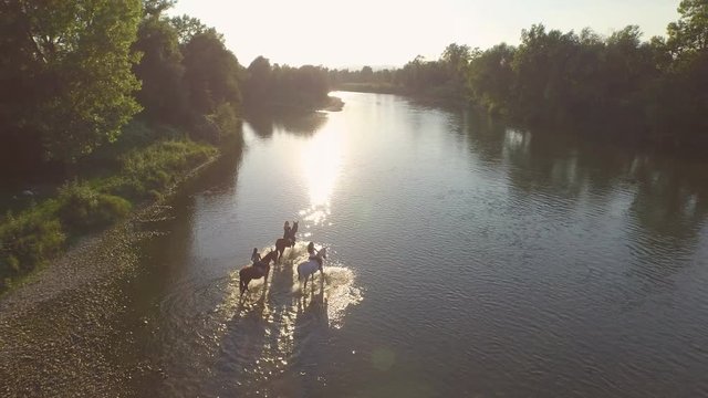 CLOSE UP: Three girlfriends riding horses in the river at beautiful sunny day