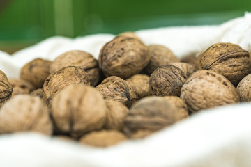 Pile of whole fresh walnuts in their shells
