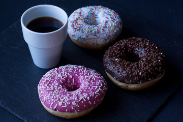 donuts and coffee on a black background