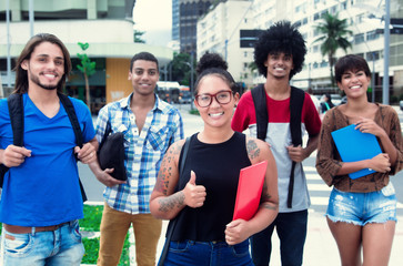 Lachende Studentin mit Brille und anderen Studenten