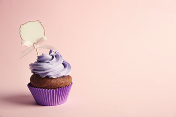 Birthday cupcake with space for text on lilac background