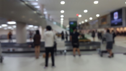 Blurry abstract Travelers waiting for their luggage at the bagga